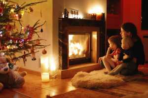 3 children infront of an open fire at Christmas